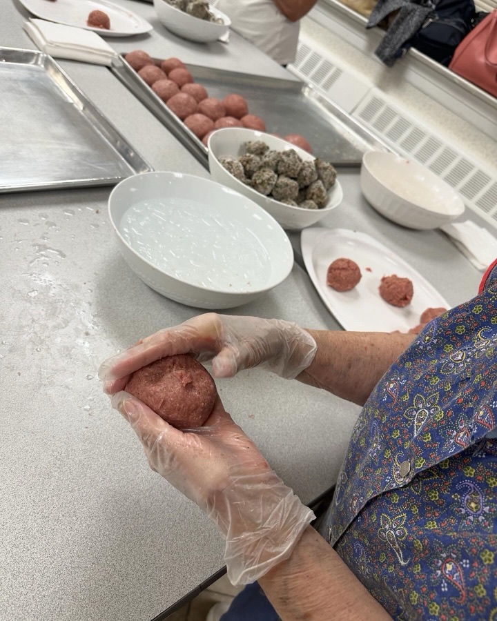 Volunteers hand-rolling kufteh